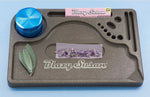 Blazy Susan lavender hemp plastic rolling tray with rolling papers, grinder, and decorative herbs, showcasing an organized and stylish setup