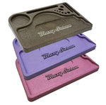 Stacked Blazy Susan hemp plastic rolling trays in brown, purple, and pink, perfect for organizing rolling accessories with eco-friendly design.