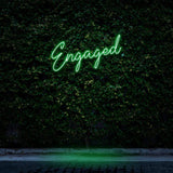 Engaged green neon sign for wedding decor, ideal for photo backdrops and celebrations.