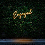 Engaged orange
 neon sign for event lighting, enhancing celebrations with warm glow.c