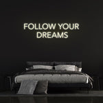 Energy-efficient Follow Your Dreams neon sign with vibrant LED lighting for home or office wall decor.