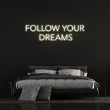 Energy-efficient Follow Your Dreams neon sign with vibrant LED lighting for home or office wall decor.