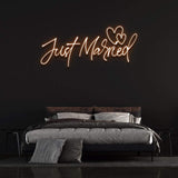 Just Married LED neon sign in orange – romantic and stylish wedding decor for venues, easily portable and customizable for special events.