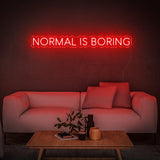 Bold red 'Normal Is Boring' LED neon sign, a perfect quirky statement piece to inspire creativity and highlight your unique style in any room.